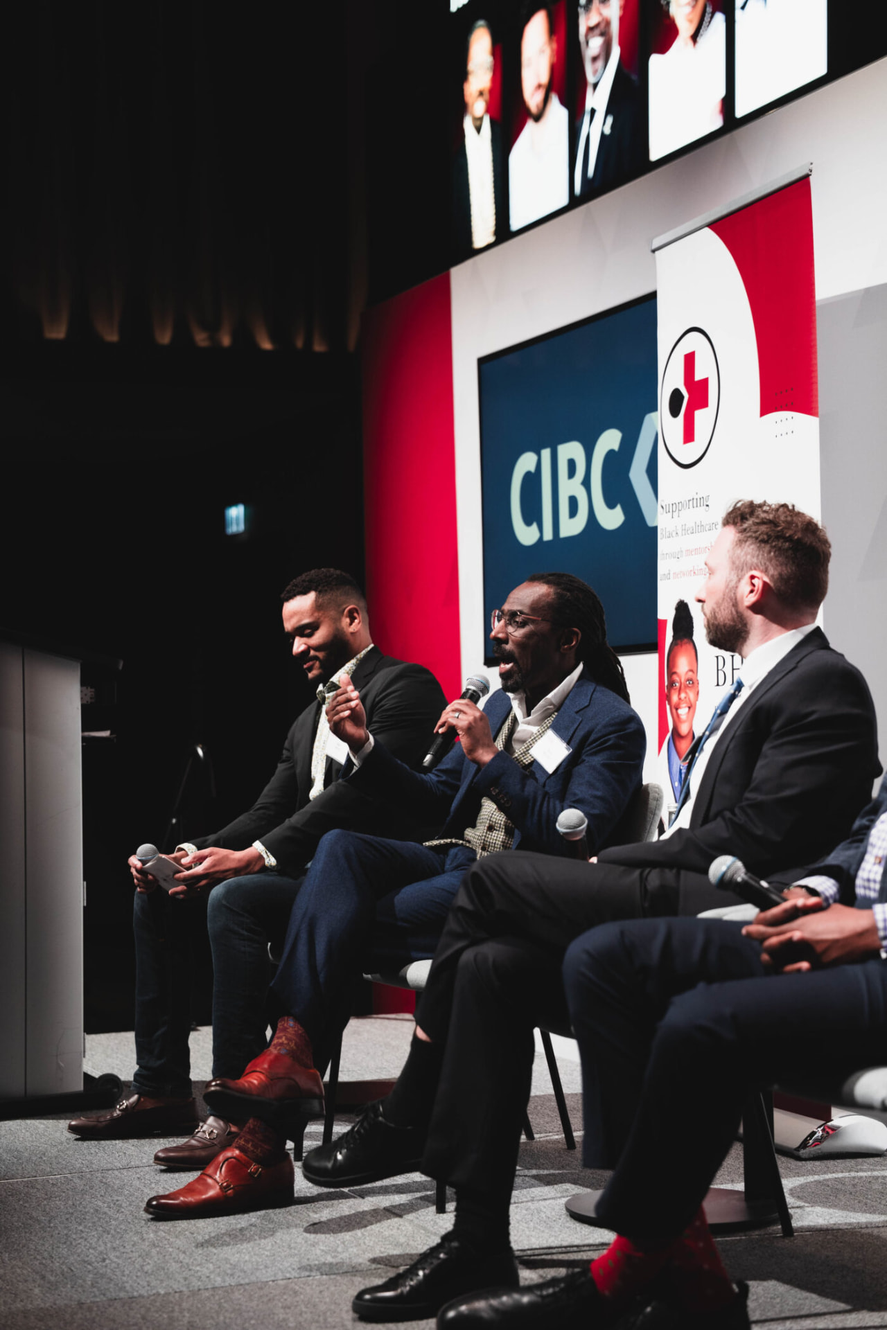 Panelists in conversation on stage at a BHPN event